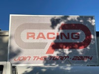 a sign that says racing on the side of a building