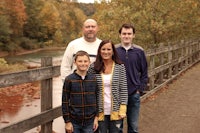 a family posing for a photo on a bridge