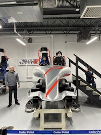 a man is standing next to a wheelchair in a garage