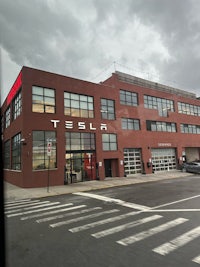 a tesla building with a car in front of it